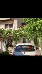 a white car parked in front of a building at Domenii House in Bucharest