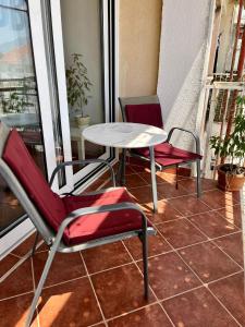 two chairs and a table on a balcony at Tivat Centar Apartment in Tivat