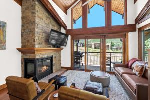 a living room with a fireplace and a couch at Crestwood 1303 Deluxe 1 Bedroom plus Loft in Snowmass Village