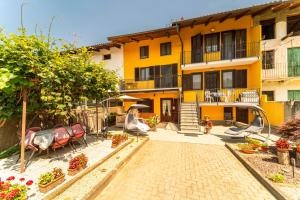 a yellow apartment building with a playground in front of it at Spighe Paglia e Girasole in Candia Canavese