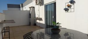 a glass table with a potted plant on a balcony at Apartamento Duplex em Condomínio com portaria in Uberaba +4 photos