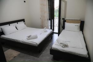 two beds sitting next to each other in a room at Roan Luxury Villa in Vlorë +31 photos