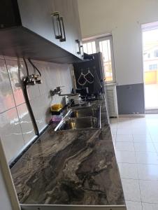 a kitchen with a sink and a counter top at Dreamer's Den Hostel and Tours in Yerevan