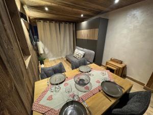 a table with glasses and plates on top of it at Studio pied des pistes Les Gets - 4 pers rénové in Les Gets