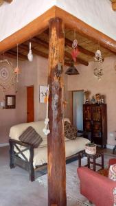 a room with a bed and a couch in a room at El Quitapenas Tilcara in Tilcara