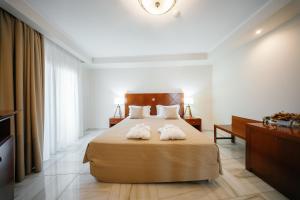 Postel nebo postele na pokoji v ubytování Nefeli Hotel