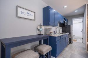 a kitchen with blue cabinets and a blue island at Sunset Villa B5 in Bridgman +1 photo