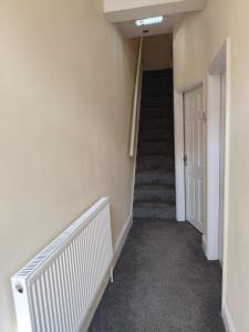 a hallway with stairs and a stair case at En-Suite Double-Bedroom in the Heart of Salford Manchester CR3 Perfect for Short Stays in Manchester