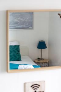 a bedroom with a bed and a blue lamp at Le Léon 13 Joli studio avec balcon situé à Dieppe in Dieppe