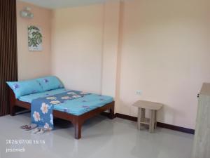 a small room with a bed and a stool at Megan and Angel Travellers Inn in Sinai +4 photos