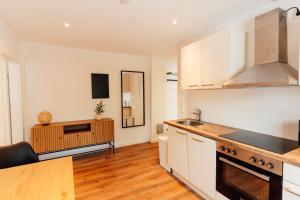 a kitchen with white cabinets and a counter top at moderne, geräumige Wohnung neco appartments in Behrenhoff