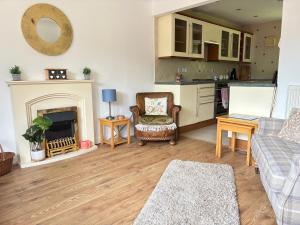 a living room with a couch and a fireplace at Arbour View in Polegate