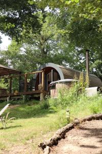 a house that is sitting in the grass at Pods At Buckland's Glamping in Handcross