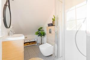 a bathroom with a toilet and a sink at Malinowka in Jantar +143 photos