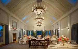 a large dining room with tables and chairs and a chandelier at 3 Bedroom Moreland Village Home 5588 in Bluffton +68 photos
