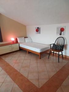 a room with a bed and a chair in it at Apartman studio Dino Klimno in Klimno