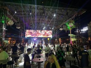 a crowd of people in a room with a large screen at Club Robin Hood Hotel Adults Only in Alanya +70 photos