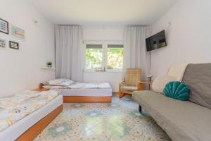 a living room with two beds and a couch at Malinowka in Jantar