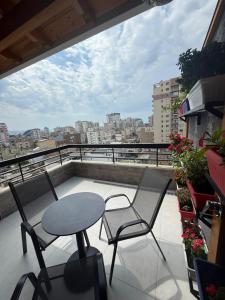 a patio with two chairs and a table on a balcony at City View Apartments in Durrës