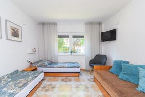 a living room with a bed and a couch at Malinowka in Jantar
