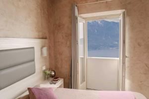 Postel nebo postele na pokoji v ubytování Hotel Miralago