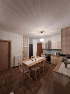 a large kitchen with a wooden table and chairs at Sea View Maisonette just 250m from the Beach Fully Equipped & Spacious! in AgiaKampos