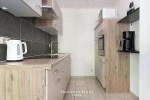 a kitchen with a sink and a counter top at Wiesenweg W03 in Laboe