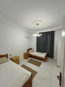 a bedroom with two beds and a window at Villa Line Midoun sans vis-à-vis in Taguermess +73 photos