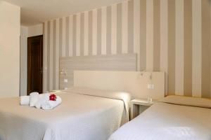 Postel nebo postele na pokoji v ubytování Hotel Miralago
