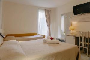Postel nebo postele na pokoji v ubytování Hotel Miralago