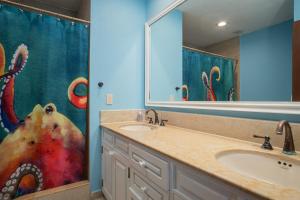 a bathroom with a sink and a large mirror at Happy-N-The-Sun 2 BR Oceanfront in Puerto Peñasco +17 photos