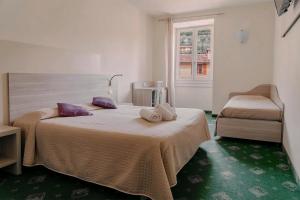 Postel nebo postele na pokoji v ubytování Hotel Miralago
