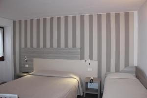 Postel nebo postele na pokoji v ubytování Hotel Miralago