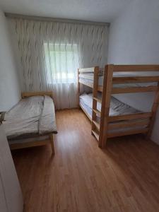 a bedroom with two bunk beds and a window at Breti's GuestHouse in Vusanje