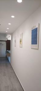 a hallway with paintings on a wall in a building at La Conchiglia Apartment Villa Margi in Santo Stefano di Camastra