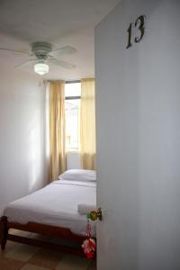 a bedroom with a bed with a number on the door at Hospedaje Los Organos in Los Órganos