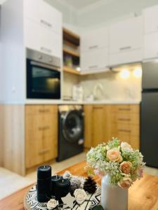 una cocina con una mesa con un jarrón de flores en Blue Studio Houses, en Samos