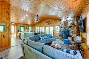 a living room with a couch and a stone fireplace at Yellow Mountain Vista Echoes at 4400 in Cullowhee