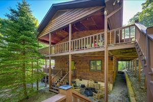 a log cabin with a staircase leading up to the upper deck at Yellow Mountain Vista Echoes at 4400 in Cullowhee