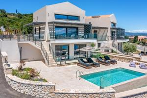 ein Bild von einem Haus mit einem Swimmingpool in der Unterkunft Ionian Hospitality Resort Suites & Villas in Nikiana