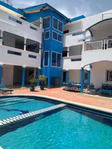 a swimming pool in front of a building at Blue House in Saly Portudal