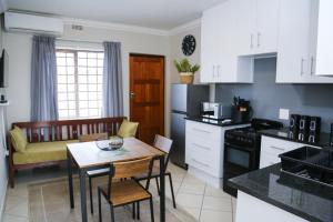 a kitchen with a table and a dining room at Schutterend in Nieuwe Drift