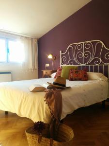 a bedroom with a large bed with a hat on it at Casa Rural Almanzor in Navarredonda de Gredos