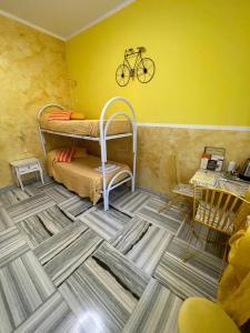 a room with two bunk beds and a bike on the wall at Hotel Serenella in Turin