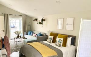 a bedroom with a bed and a couch at Shimna Vale Studio in Newcastle