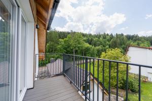 a balcony with a view of the woods at Apartamenty Dolina Jawornika in Wisła