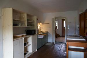 a kitchen with white cabinets and a sink in it at Vintage Lake House Bohinj in Bohinj