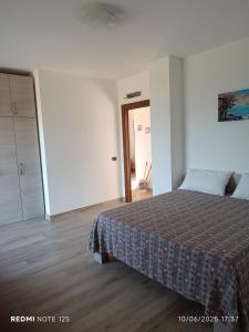 a bedroom with a bed and a closet and a door at La Dimora di Nonna Anna in Casal Velino +17 photos