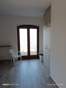 a room with a table and a chair and a window at La Dimora di Nonna Anna in Casal Velino