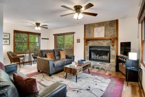 a living room with a couch and a fireplace at Elk Ridge Retreat -Hot Tub- Firepit-Fireplace in Maggie Valley